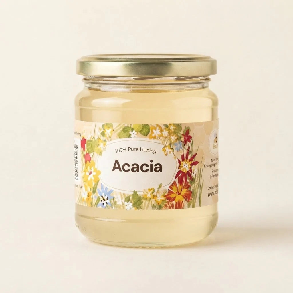 A glass jar of Acacia honey with a gold metal lid and a colorful floral label, set against a plain off-white background.